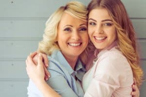 mother and daughter close smiling